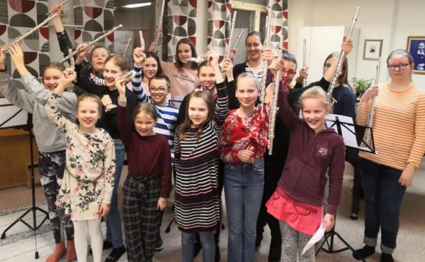 hymyileviä huilun soiton opiskelijoita huilut kädessään